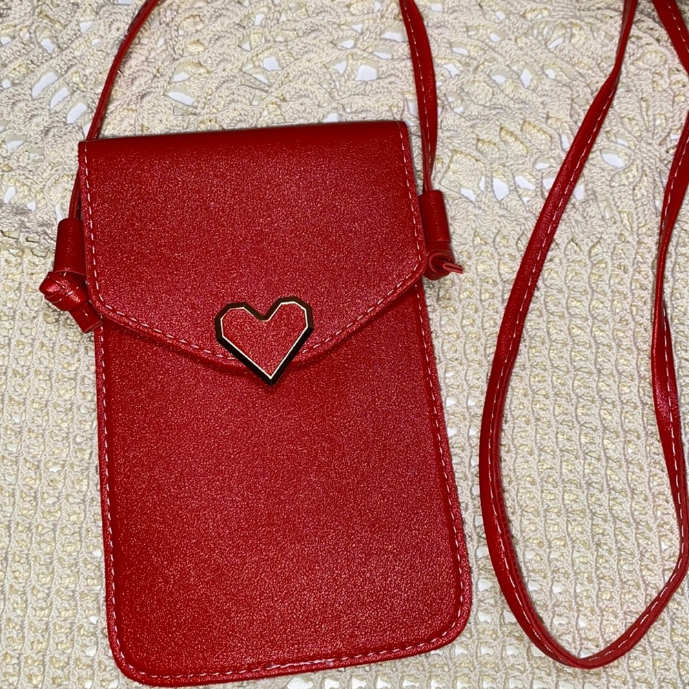 3/$15 Red faux leather crossbody with heart snap and clear back